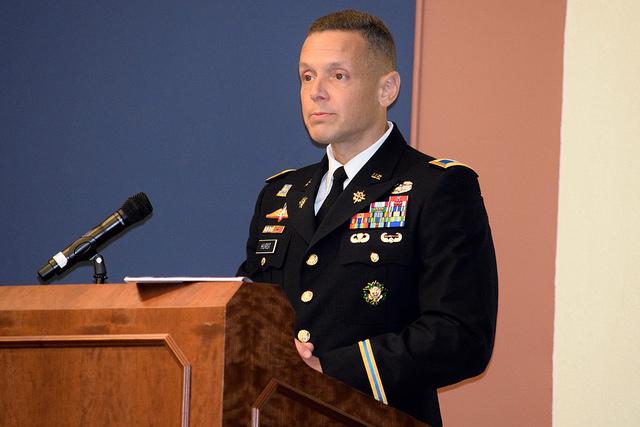 Soldier speaks behind podium.